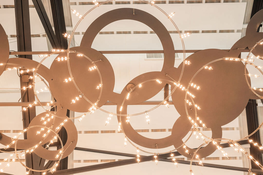 A close-up of an intricate chandelier with circular designs and fairy lights, adding a whimsical and romantic ambiance to the venue's interior.