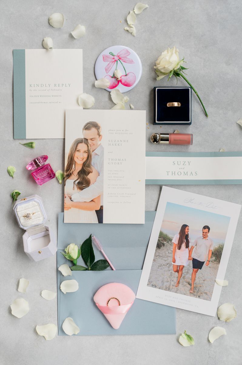 details from a couple's wedding day including their wedding invitations, rings, and flowers